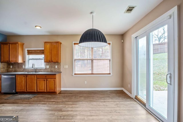 6498 Stonelake Pl SW, Atlanta, GA 30331 - kitchen with a sink, dishwasher, brown cabinetry, and light wood-type flooring