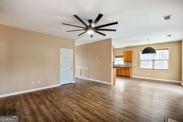 6498 Stonelake Pl SW, Atlanta, GA 30331 - unfurnished living room with dark wood-style flooring, a ceiling fan, and baseboards