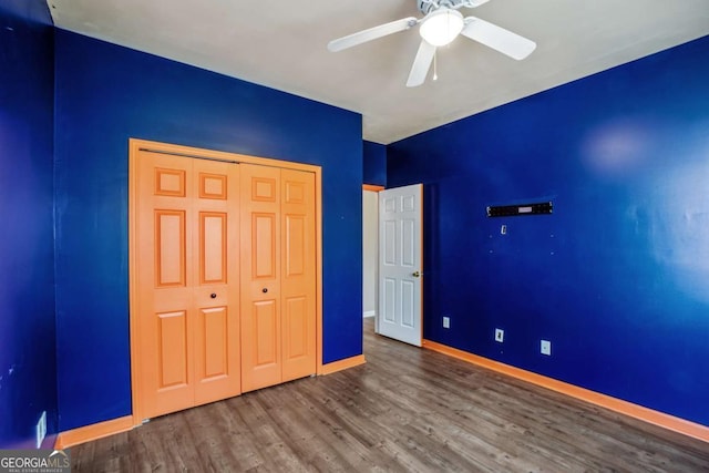 6498 Stonelake Pl SW, Atlanta, GA 30331 - unfurnished bedroom with wood finished floors, baseboards, a closet, and ceiling fan