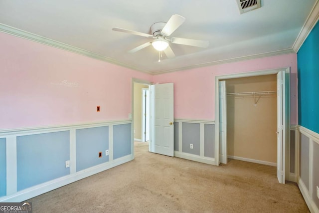 6498 Stonelake Pl SW, Atlanta, GA 30331 - unfurnished bedroom featuring carpet, ornamental molding, a closet, a ceiling fan, and a wainscoted wall