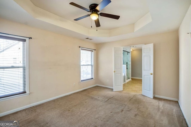 6498 Stonelake Pl SW, Atlanta, GA 30331 - unfurnished bedroom with a tray ceiling, carpet flooring, baseboards, and ceiling fan