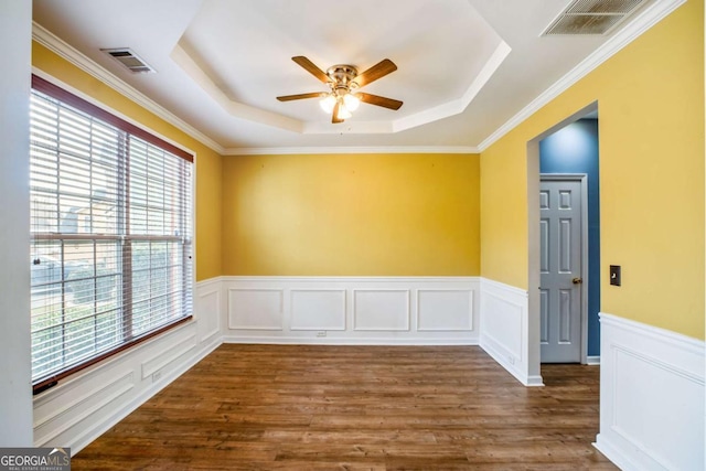 6498 Stonelake Pl SW, Atlanta, GA 30331 - unfurnished room with healthy amount of natural light, a tray ceiling, ceiling fan, a wainscoted wall, and wood finished floors