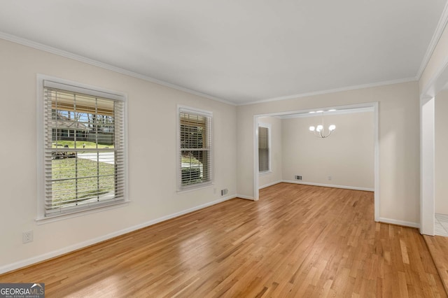 empty room with crown molding, light wood-style floors, baseboards, and a notable chandelier