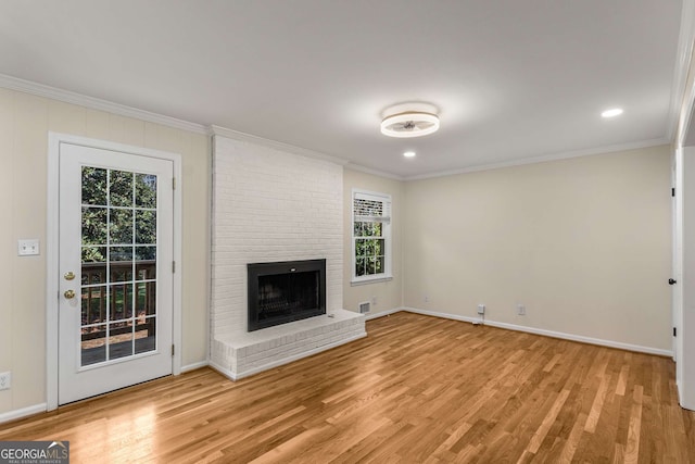 unfurnished living room with light wood-type flooring and crown molding