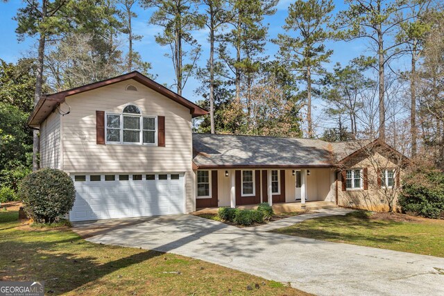 2542 Maclaren, Dunwoody, GA 30360 - view of front of house featuring covered porch, concrete driveway, a garage, and a front lawn