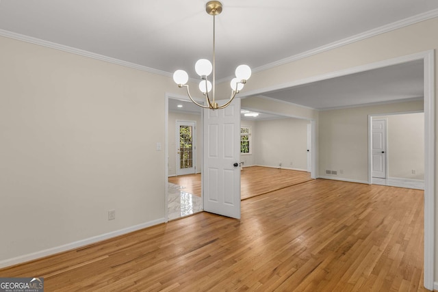 unfurnished dining area with a chandelier, wood finished floors, visible vents, baseboards, and ornamental molding