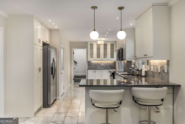 2542 Maclaren, Dunwoody, GA 30360 - kitchen featuring stainless steel appliances, a peninsula, light marble finish flooring, decorative backsplash, and recessed lighting