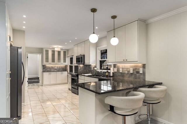 2542 Maclaren, Dunwoody, GA 30360 - kitchen with stainless steel microwave, freestanding refrigerator, electric range, a peninsula, and light marble finish floors