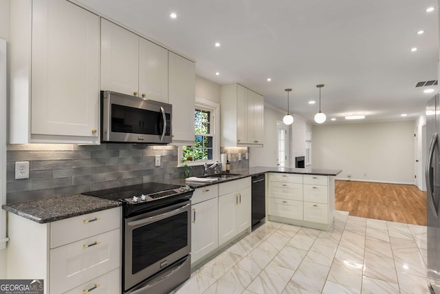 2542 Maclaren, Dunwoody, GA 30360 - kitchen with appliances with stainless steel finishes, a peninsula, tasteful backsplash, recessed lighting, and a sink