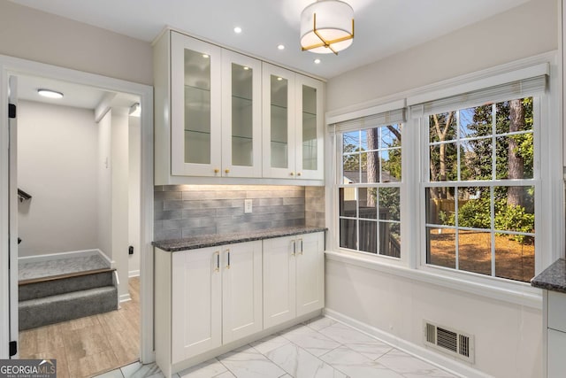 2542 Maclaren, Dunwoody, GA 30360 - bar with baseboards, backsplash, recessed lighting, light marble finish floors, and stairway