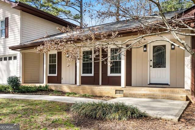 2542 Maclaren, Dunwoody, GA 30360 - entrance to property with a porch and a garage