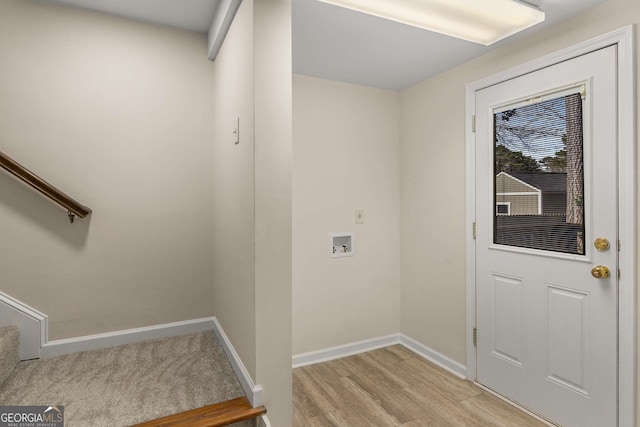 doorway featuring light wood-style floors, stairs, and baseboards