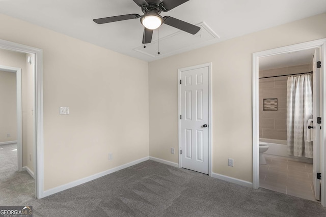 unfurnished bedroom with carpet, attic access, and baseboards