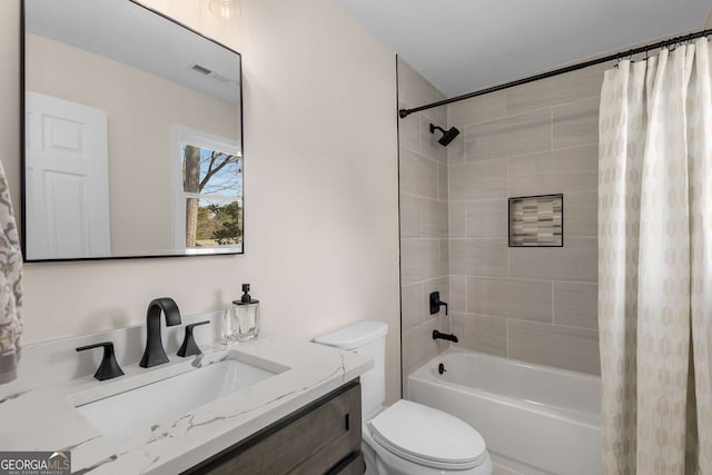 bathroom with shower / bath combo, visible vents, vanity, and toilet