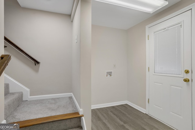 staircase with baseboards and wood finished floors