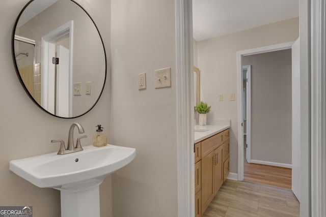 bathroom with baseboards and a sink