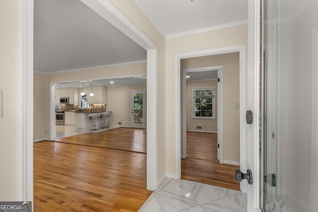 2542 Maclaren, Dunwoody, GA 30360 - foyer featuring ornamental molding, baseboards, and light wood-type flooring
