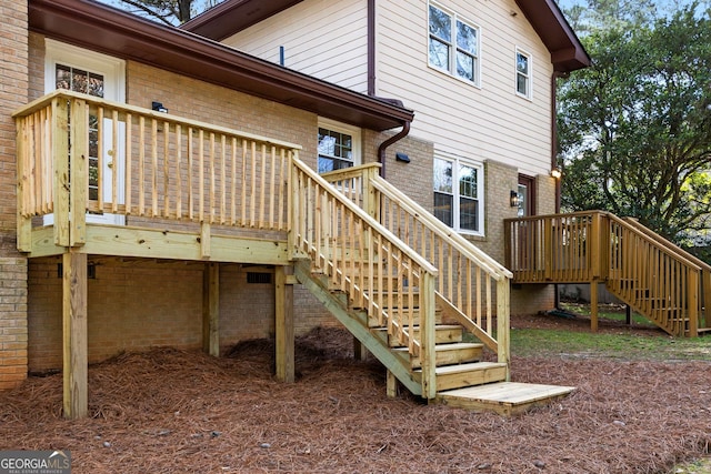 2542 Maclaren, Dunwoody, GA 30360 - rear view of house featuring stairway, brick siding, and a wooden deck