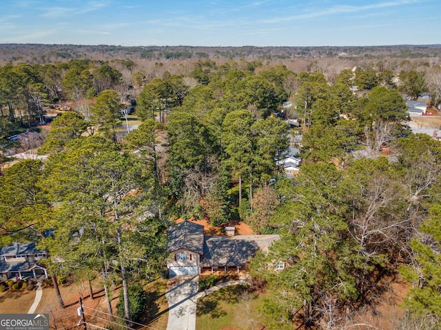 drone / aerial view featuring a forest view