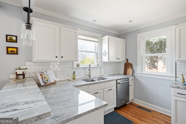 kitchen with white cabinetry, a sink, visible vents, and stainless steel dishwasher