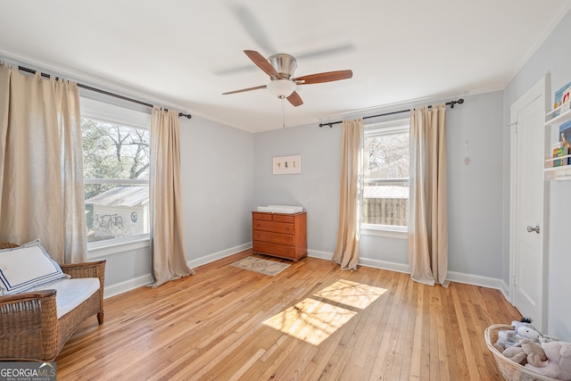 unfurnished room featuring ornamental molding, light wood-style flooring, and baseboards