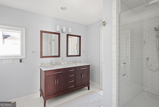 full bathroom featuring double vanity, baseboards, a sink, and tile patterned floors