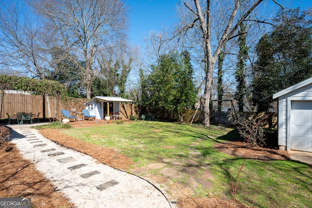 view of yard featuring an outbuilding and fence