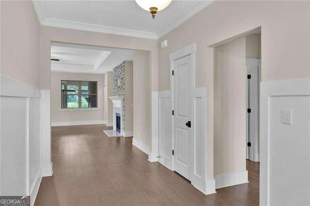 hall with crown molding and wood finished floors