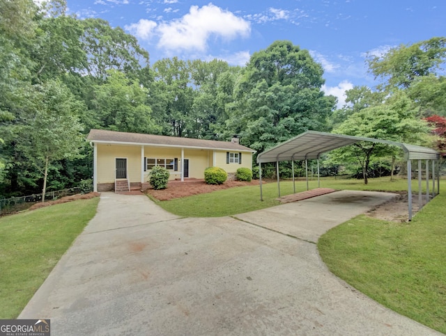 view of front of house featuring covered porch, a front yard, and a carport