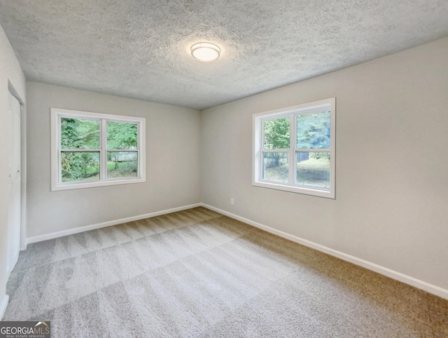 170 Pinehurst Dr, Stockbridge, GA 30281 - empty room with healthy amount of natural light, carpet flooring, and a textured ceiling