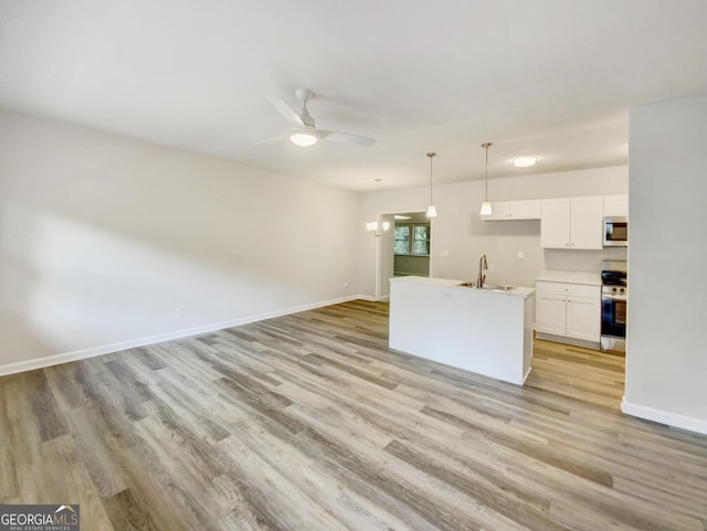 170 Pinehurst Dr, Stockbridge, GA 30281 - unfurnished living room featuring light wood finished floors and ceiling fan