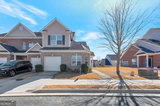 view of front of home with brick siding, driveway, and a garage