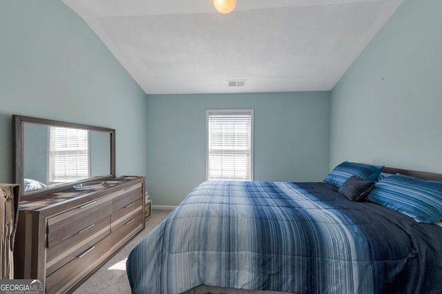 bedroom featuring vaulted ceiling, visible vents, baseboards, and carpet