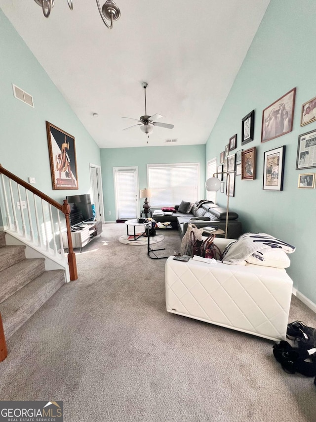 living room with ceiling fan, carpet flooring, and high vaulted ceiling