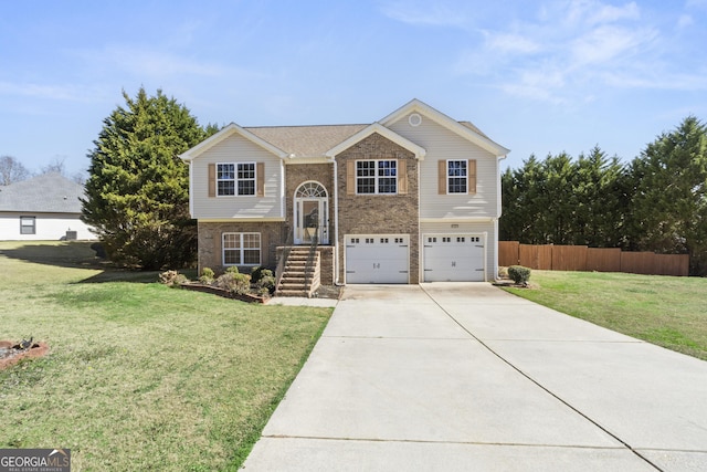 raised ranch featuring a front yard and a garage