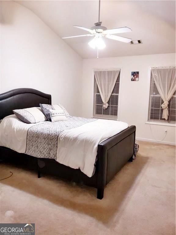 bedroom with ceiling fan, vaulted ceiling, and light carpet