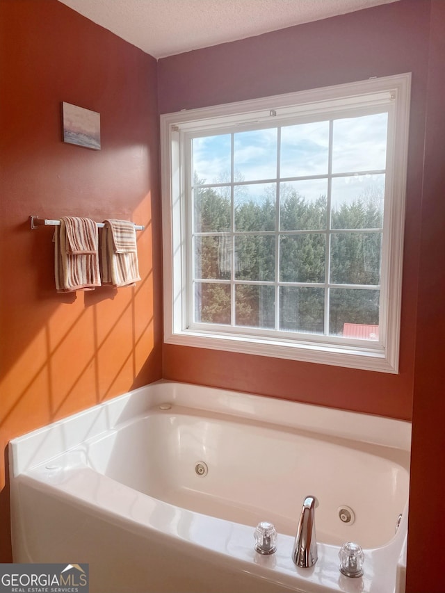 bathroom with a bathtub and a textured ceiling