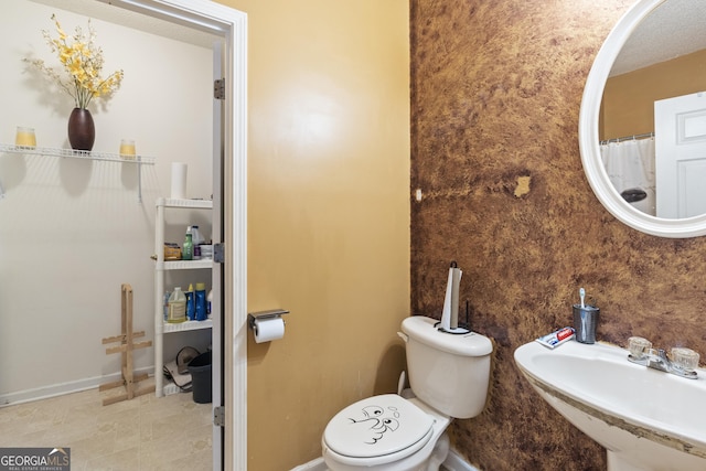 bathroom featuring sink and toilet