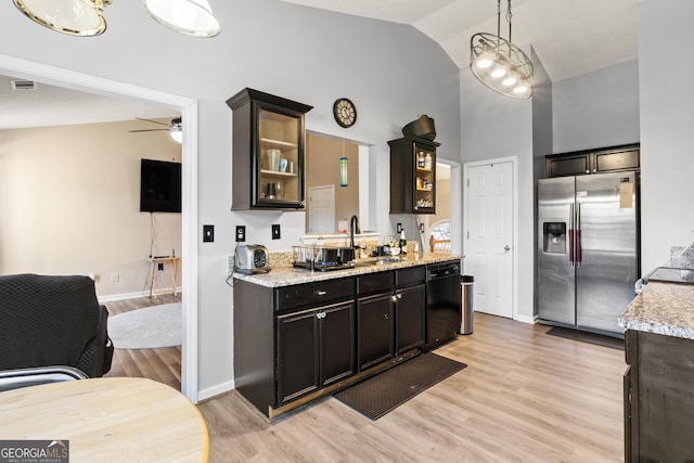 kitchen with dishwasher, hanging light fixtures, stainless steel fridge with ice dispenser, and light stone countertops