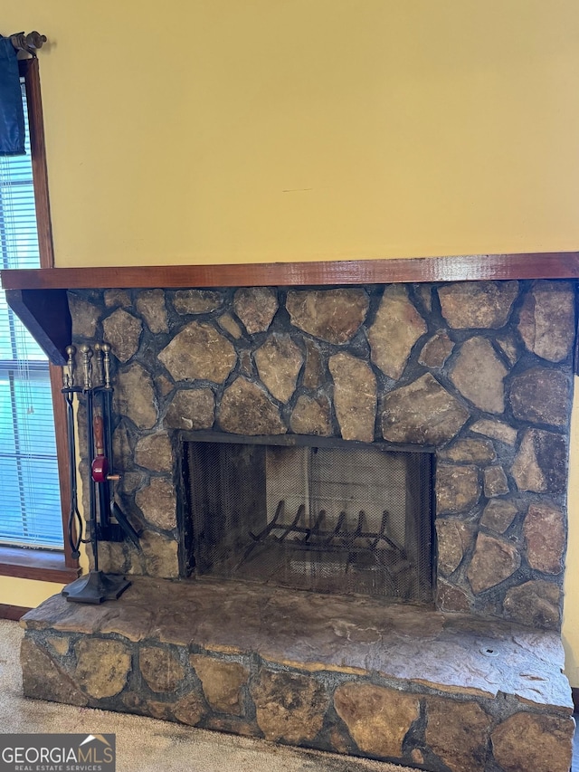 interior details featuring a stone fireplace