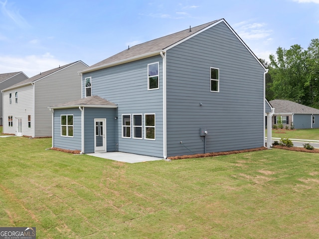 back of property with a patio and a yard