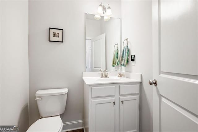 bathroom with toilet and vanity