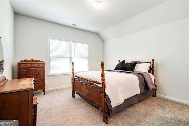 carpeted bedroom with vaulted ceiling