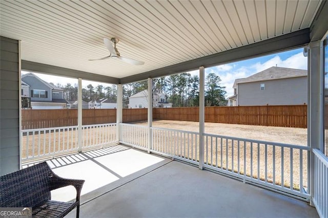 unfurnished sunroom featuring ceiling fan