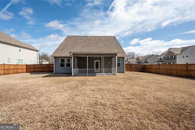 rear view of house featuring a lawn