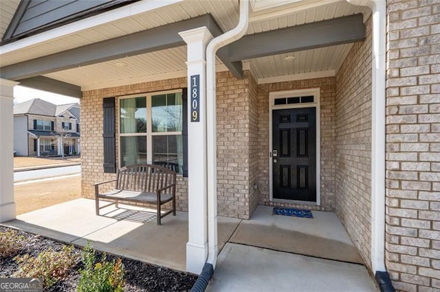 doorway to property featuring covered porch