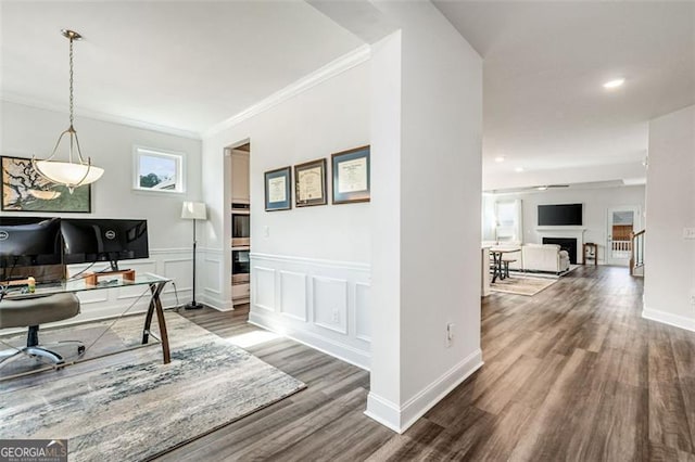 office area with hardwood / wood-style floors and crown molding