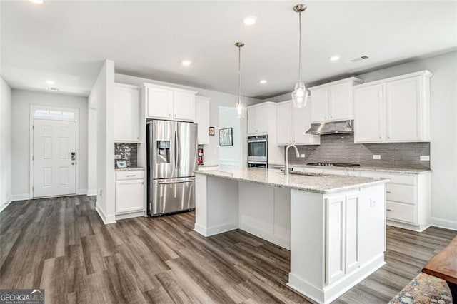 kitchen with white cabinetry, pendant lighting, an island with sink, and stainless steel fridge