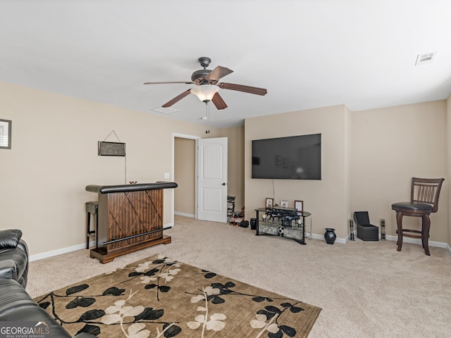 living room with ceiling fan and carpet flooring