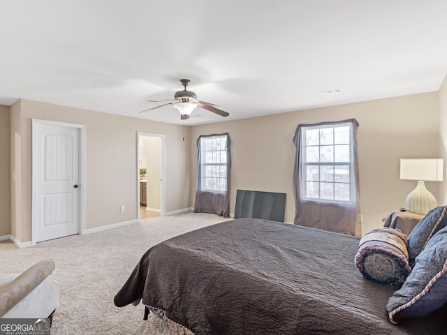 bedroom with multiple windows, ceiling fan, and light colored carpet